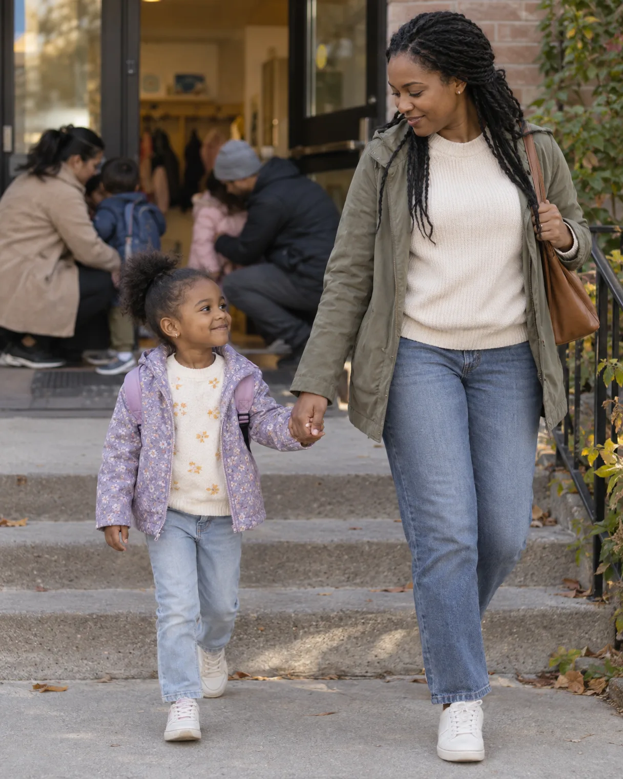 A daycare pickup at the door: a girl takes her mother’s hand and leaves while other parents behind them are still coaxing their children